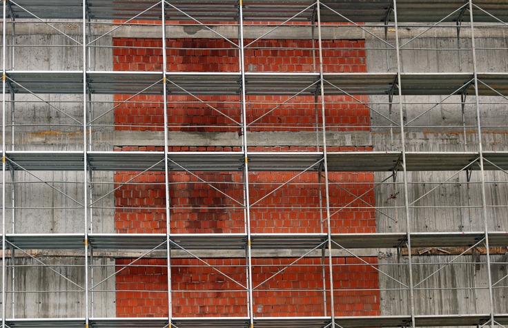 new building construction site with scaffolding platforms